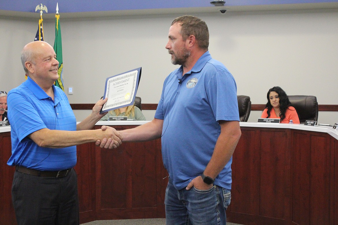 Othello Mayor Shawn Logan, left, presents a certificate of appreciation to Jon Erickson for his work on the Othello City Council. Erickson resigned from the council Monday after nearly four years on the city’s governing body. He expressed appreciation for the city’s residents, staff and elected officials for their aid during his tenure.