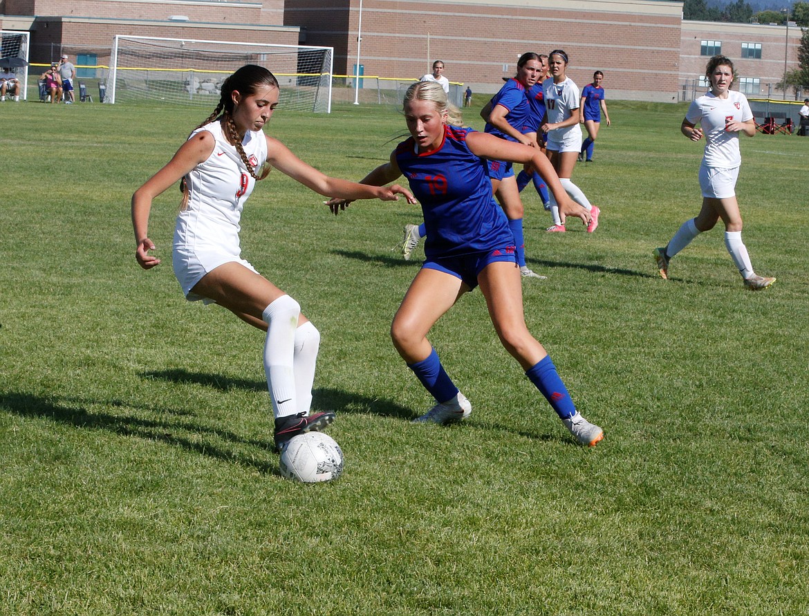 JASON ELLIOTT/Press
Sandpoint sophomore defender Ava Glahe dribbles past the defense of Coeur d'Alene junior defender Kaylie Smart during the first half of a scrimmage at Lake City High on Tuesday.