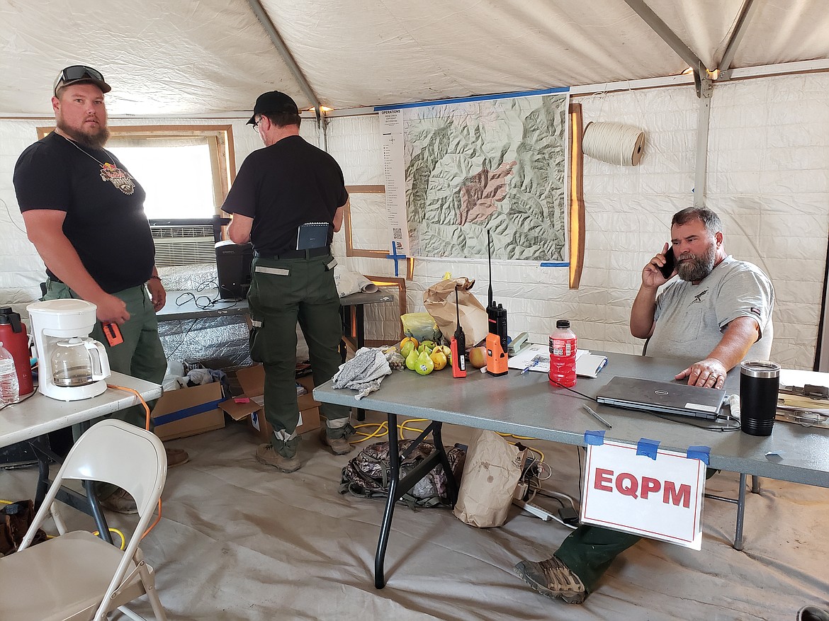 Left, Equipment Manager trainee Aaron Malson distributes equipment to the Ridge Creek Fire's front line as quickly as possible. He distributes rental vehicles, delivers pumps, and mostly files paperwork to keep the crews equipped with what they need.