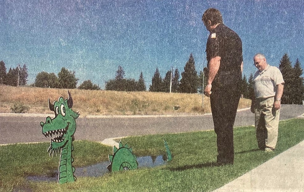 Lt. Scot Haug and Mayor Clay Larkin viewed the swamp creature that appeared in a troublesome swale after the new Post Falls Police Department opened.