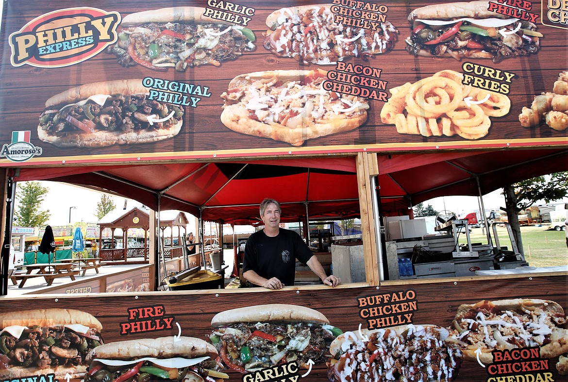 Ron Nelson, owner of Philly Express, takes a break from setting up a booth for the North Idaho State Fair on Wednesday.