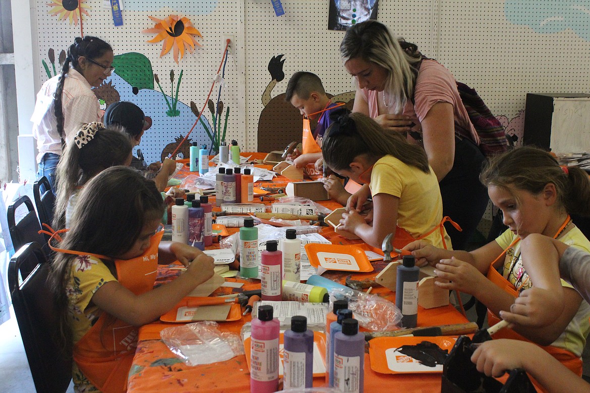 Children pound and paint away on a project in the Kids Workshop, sponsored by the Home Depot, at the Grant County Fair Wednesday.