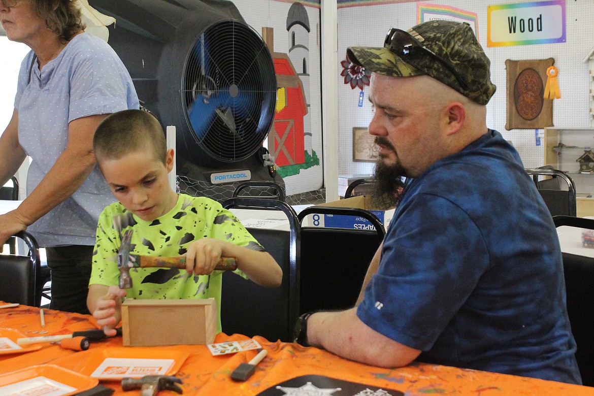 Steven Goodwin, left, cautiously proceeds on his construction project, with the help of his dad Jack Goodwin, right.