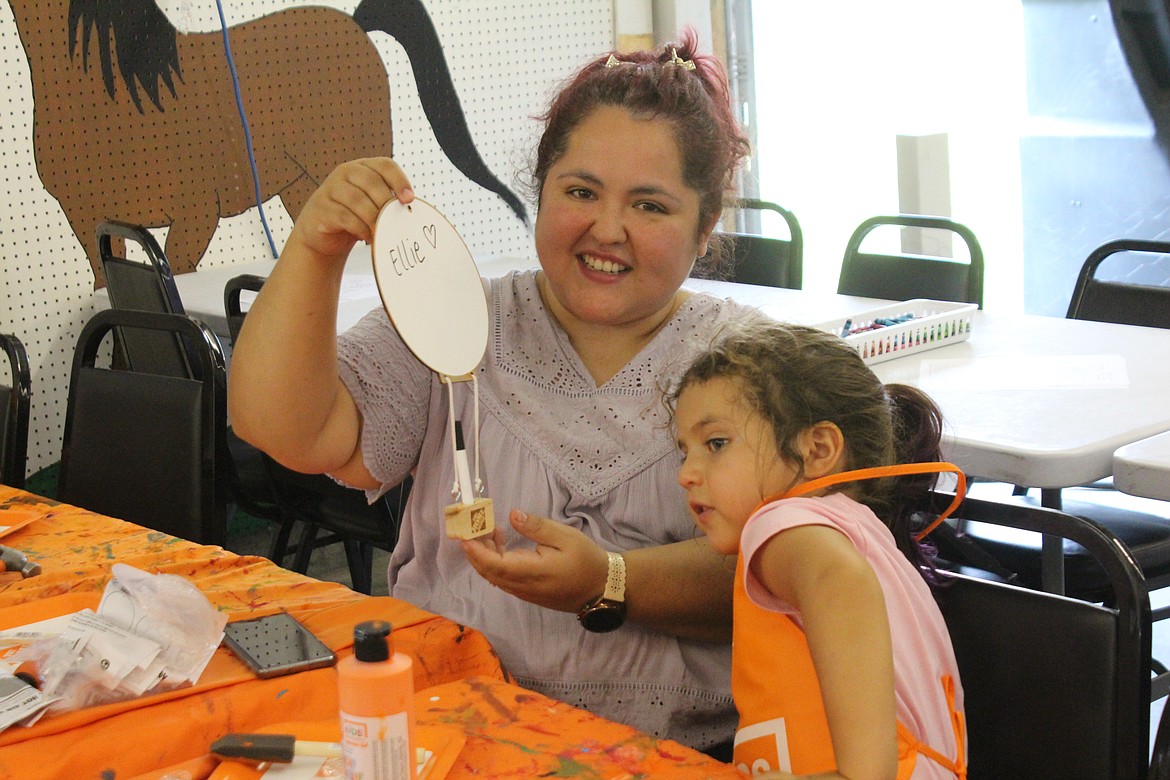 Ellie Zollinger, right, and her mom Arianna Zollinger, left, show off Ellie’s completed project.