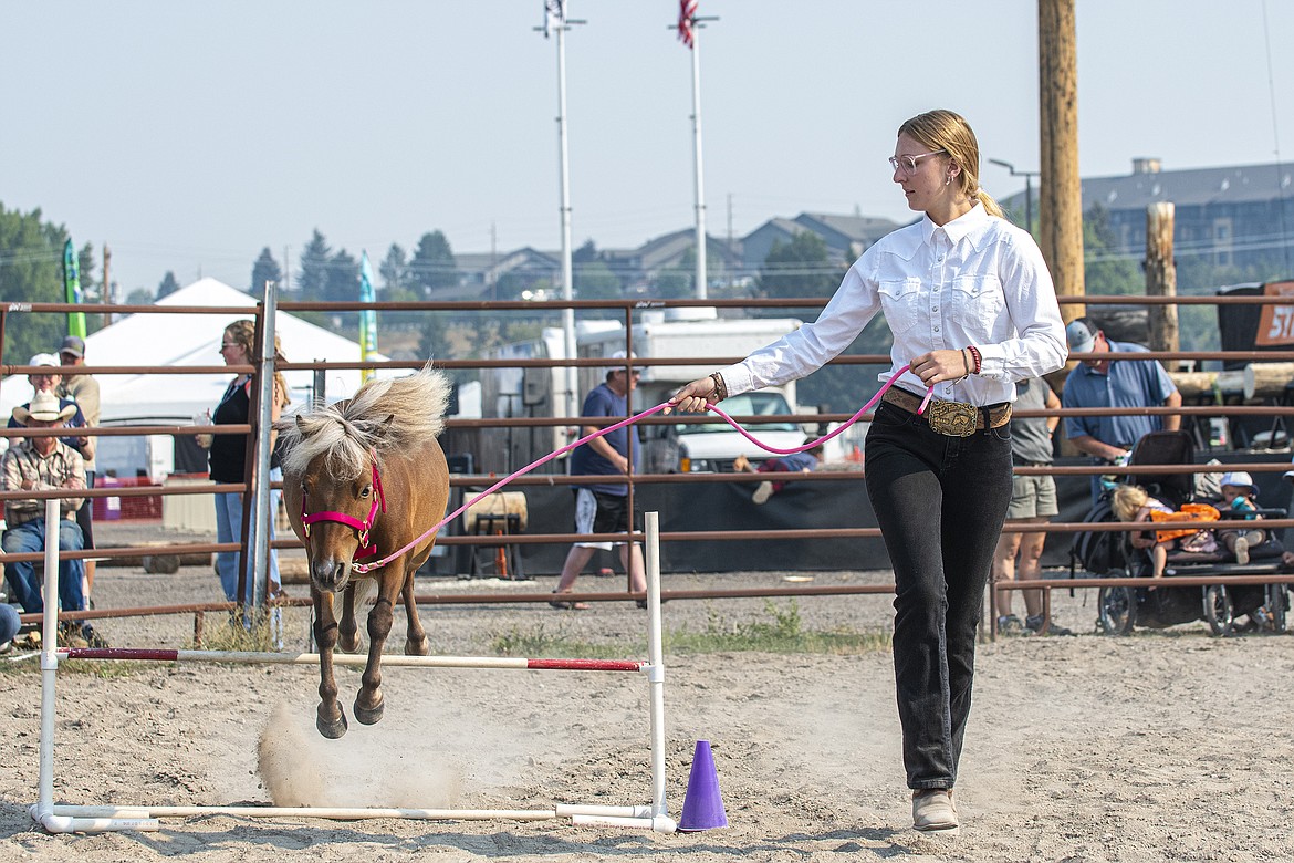 Lily Joern leads her horse through a jump during the Miniature Horse Show at Flathead County Fairgrounds on Thursday, Aug. 17. (Avery Howe/Hungry Horse News)