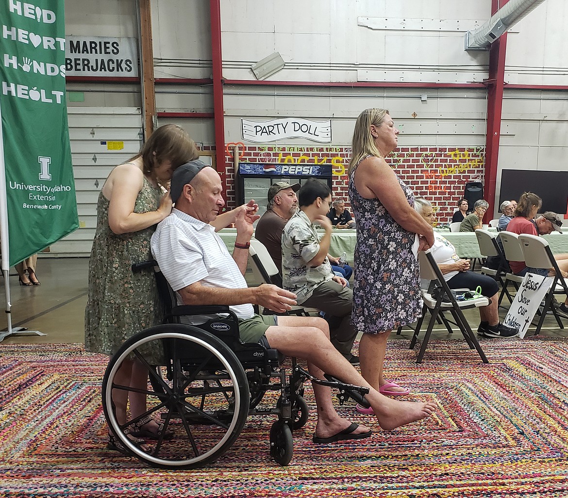 From left, Nicole, Chuck and Liz Ricciardi ask Governor Brad Little what kind of support the governmnt is working on to revitalize disability resources in the state. Nicole is developmentally disabled, and Chuck recently suffered an injury, making it harder for him to care for her.