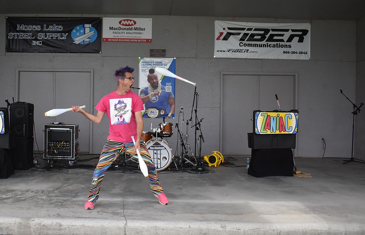 Alex Zerbe, who performs as the Professional Zaniac, keeps up an unending stream of manic patter while juggling at the Grant County Fair Thursday.