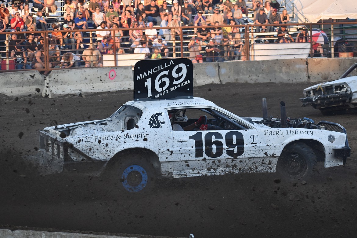 During sharp turns, demo cars kicked up dirt into the front rows of the stands at the Rodeo Arena at the Grant County Fairgrounds.