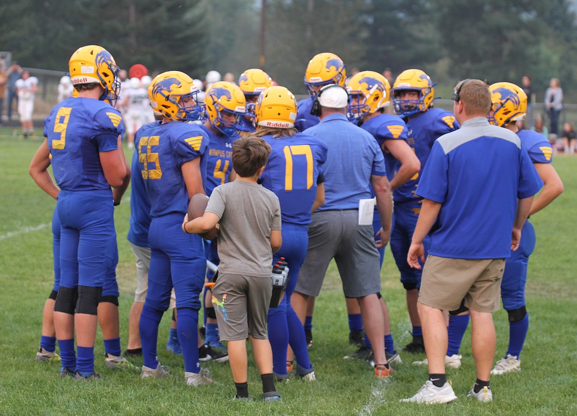 The Clark Fork Football team huddles up during a timeout near the end of the second half on Friday.