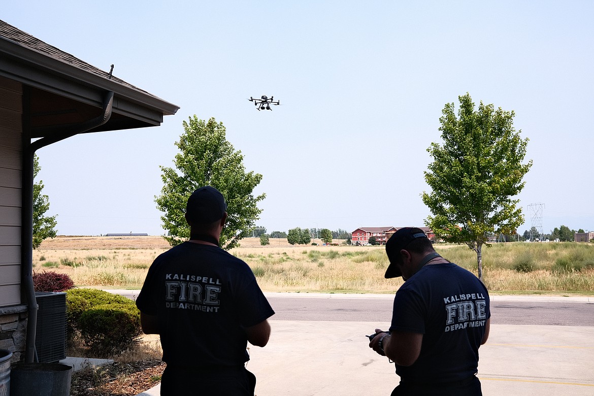 Kalispell Fire Department firefighters Jake Felts (left) and Jack Knuffke operate a new drone that will be used in haz-mat and other emergency response situations. (Adrian Knowler/Daily Inter Lake)