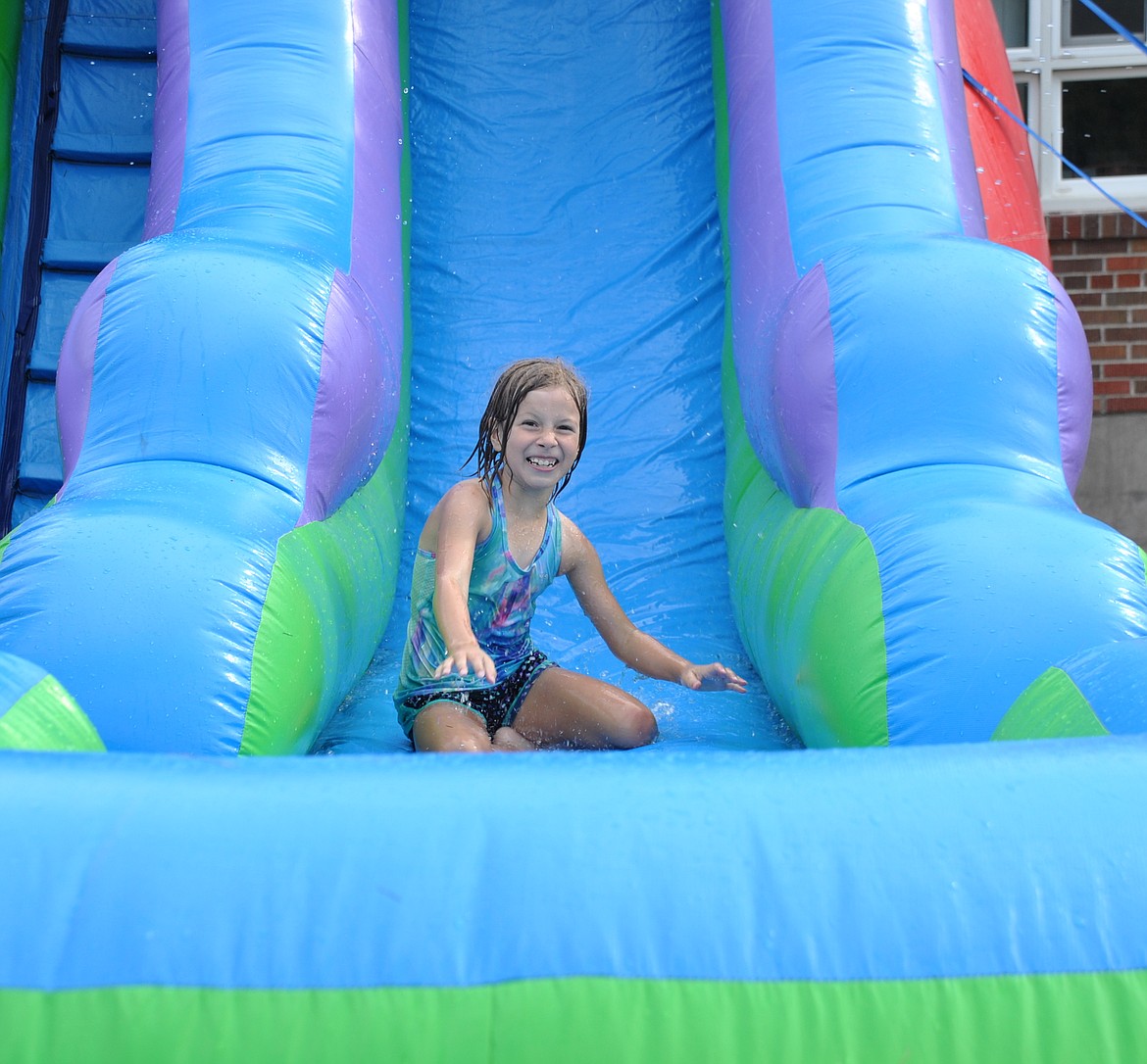 There's nothing like sliding into the end of summer, and back to school time like a blow-up water slide out on the playground. (Mineral Independent/Amy Quinlivan)