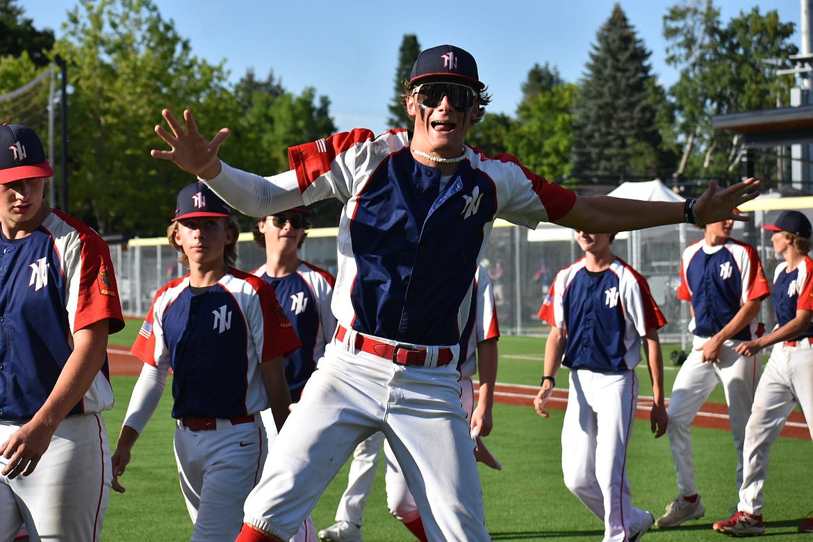 Dallen Williams is all smiles as the North Idaho Lakers make their way back to the dugout at a tournament earlier this summer.