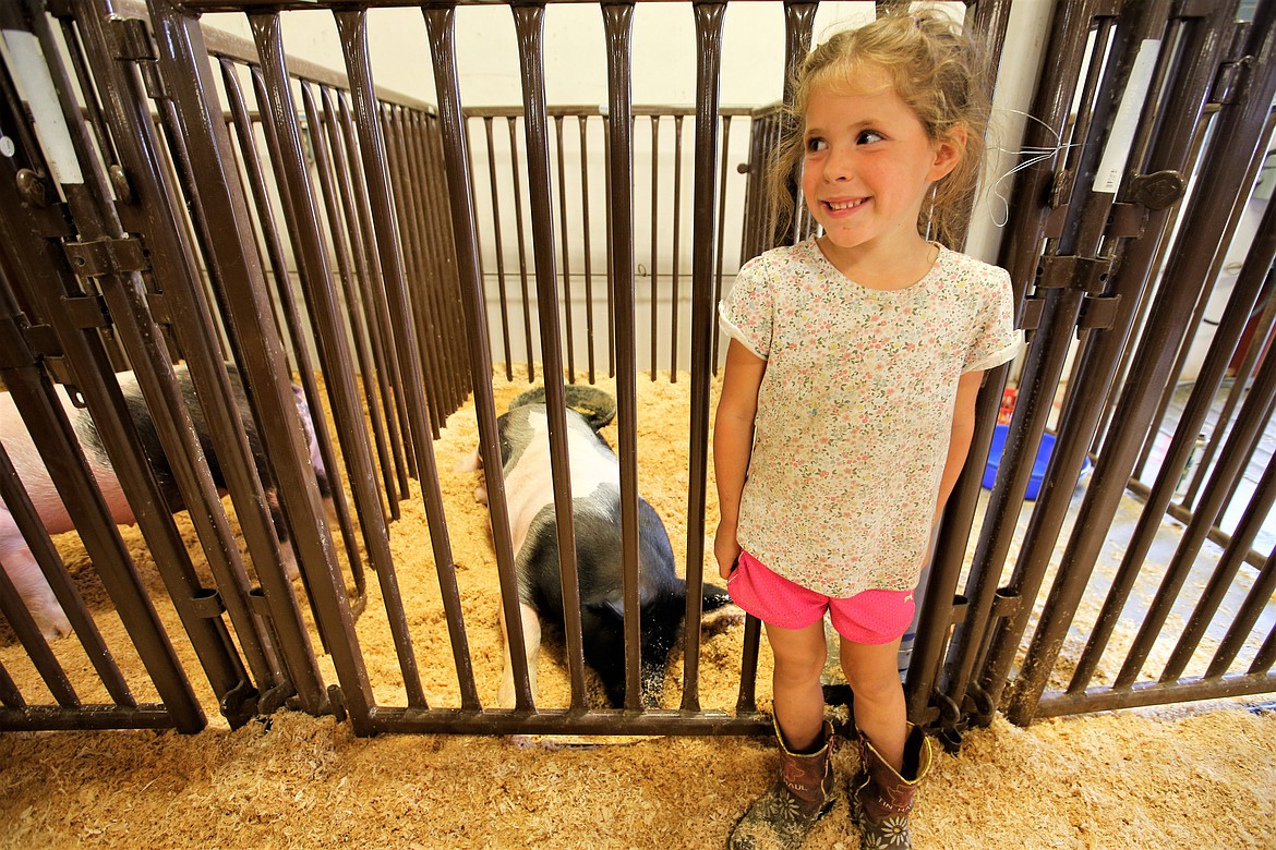 Lillee Dippolito stands in front of the kennel with her pig, "Charlie," at the North Idaho State Fair on Friday.