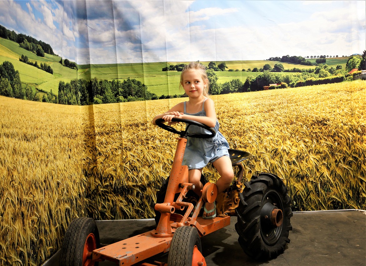 A youngster smiles as she poses in a selfie booth at the North Idaho State Fair on Friday.