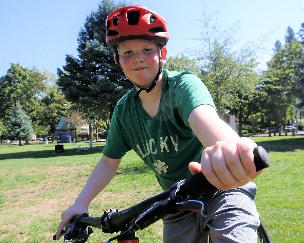 Jace McHenry smiles after riding a bike on Friday.