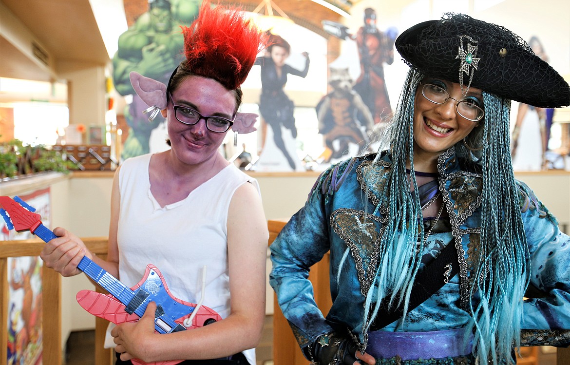 Emily Kuespert as Queen Barb from Trolls World Tour, left, and Rachel Christensen as Uma from Descendants 2 pose during Coeur d'Con at the Coeur d'Alene Public Library on Saturday.