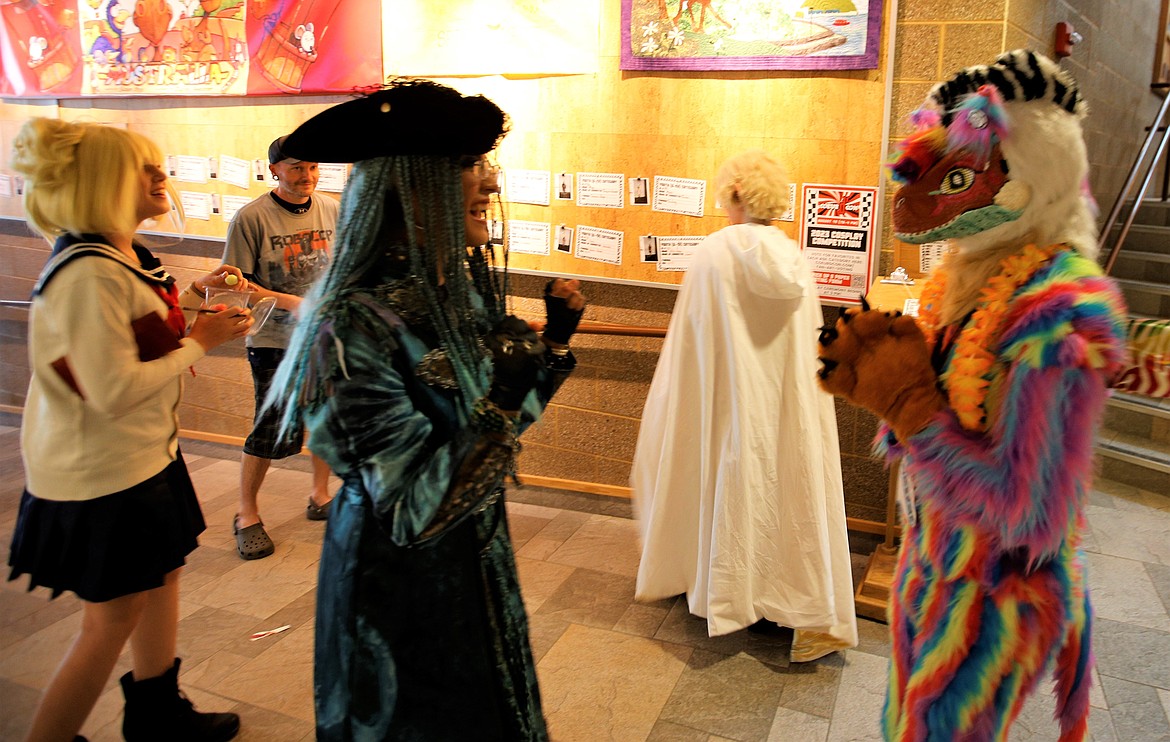 Costumed characters, including Rachel Christensen as Uma from Descendants 2, center, share some laughs at the Coeur d'Alene Public Library during Coeur d'Con on Saturday.