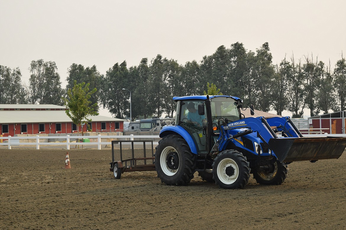 FFA tractor driving contest competitor Paul Hart maneuvers through the cones outlining the path of the tractor driving course. Competitors have two minutes and 30 seconds to complete the course – every second after the par time costs competitors a point.