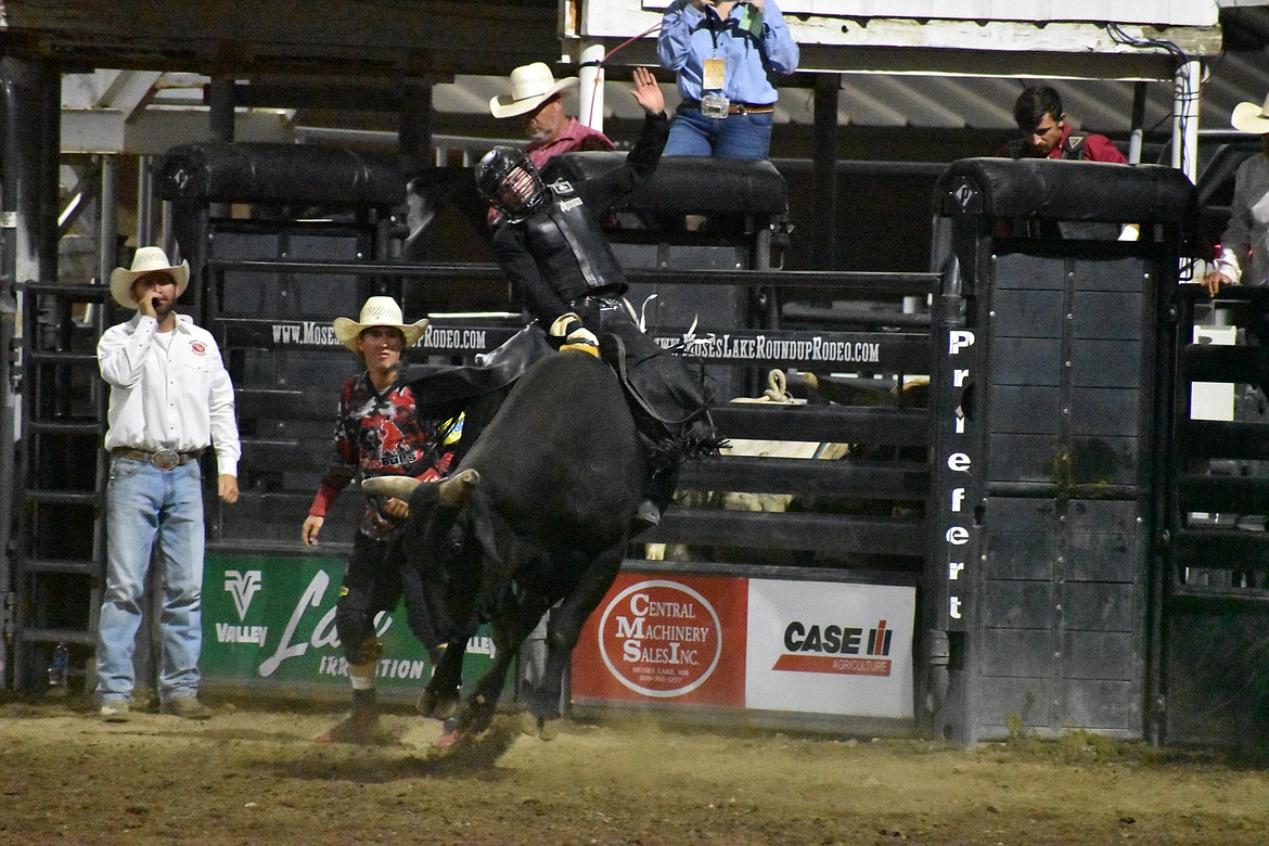 Bull rider Trevor Reiste of Linden, Iowa keeps his balance on top of the bull Make My Day on Thursday’s showing of the Moses Lake Roundup Rodeo.