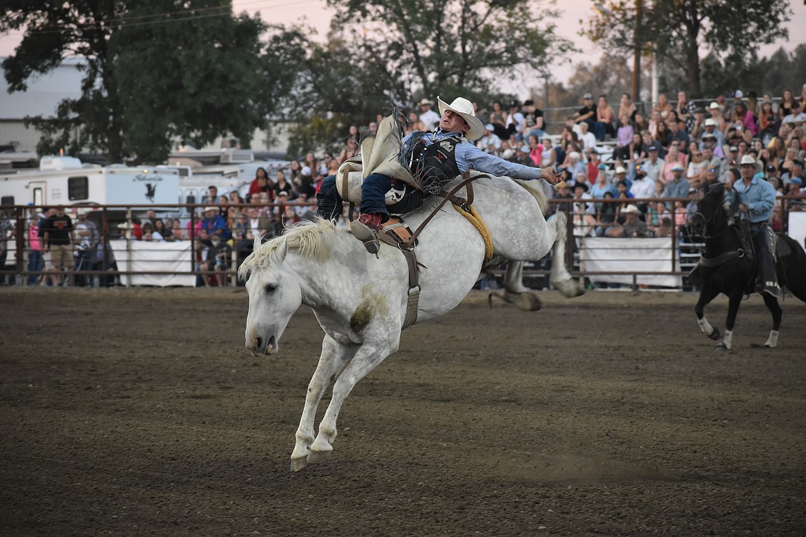 Bareback rider Jacek Frost of Browns Valley, Calif. leans back during his run in the bareback riding at the Moses Lake Roundup Rodeo on Friday.