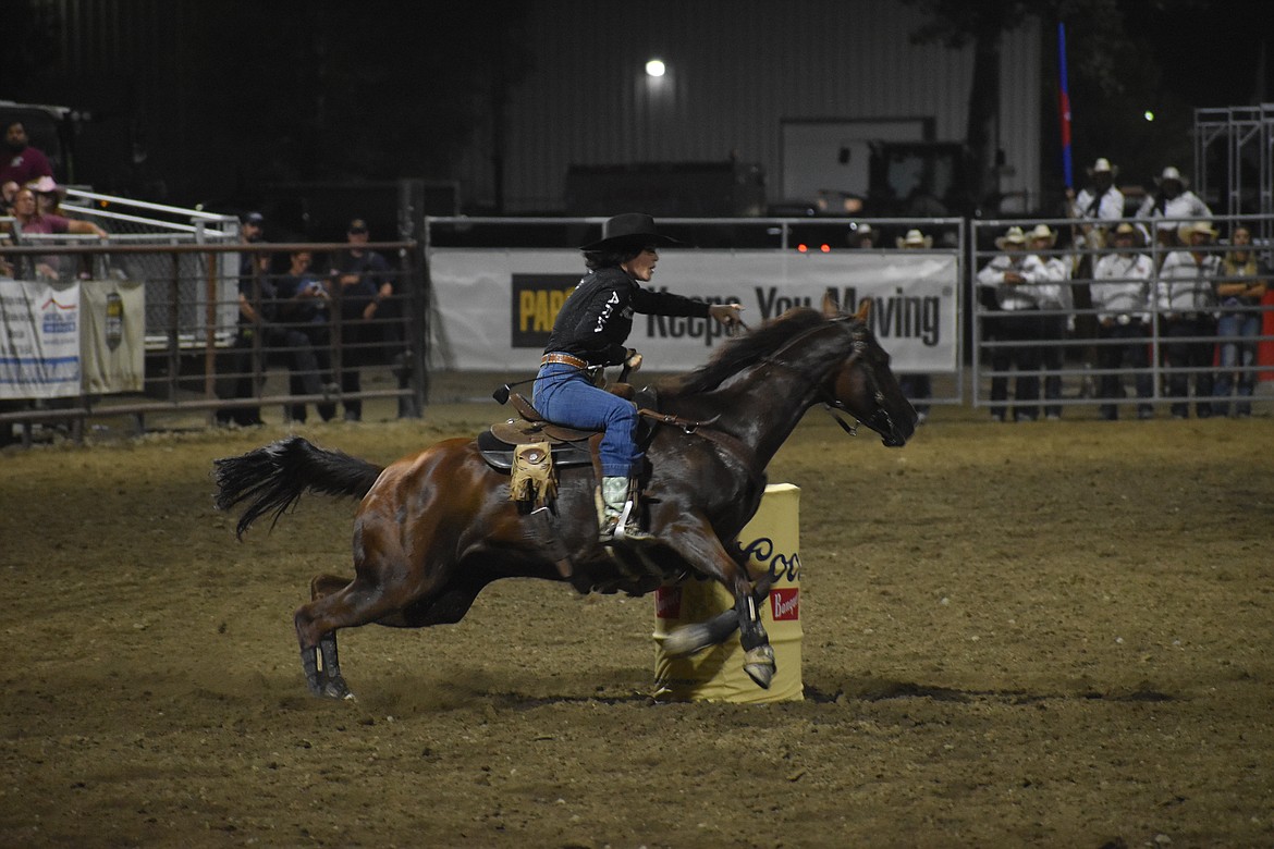 Barrel Racer Mackenzie Huggler makes a turn around a barrel on Thursday.