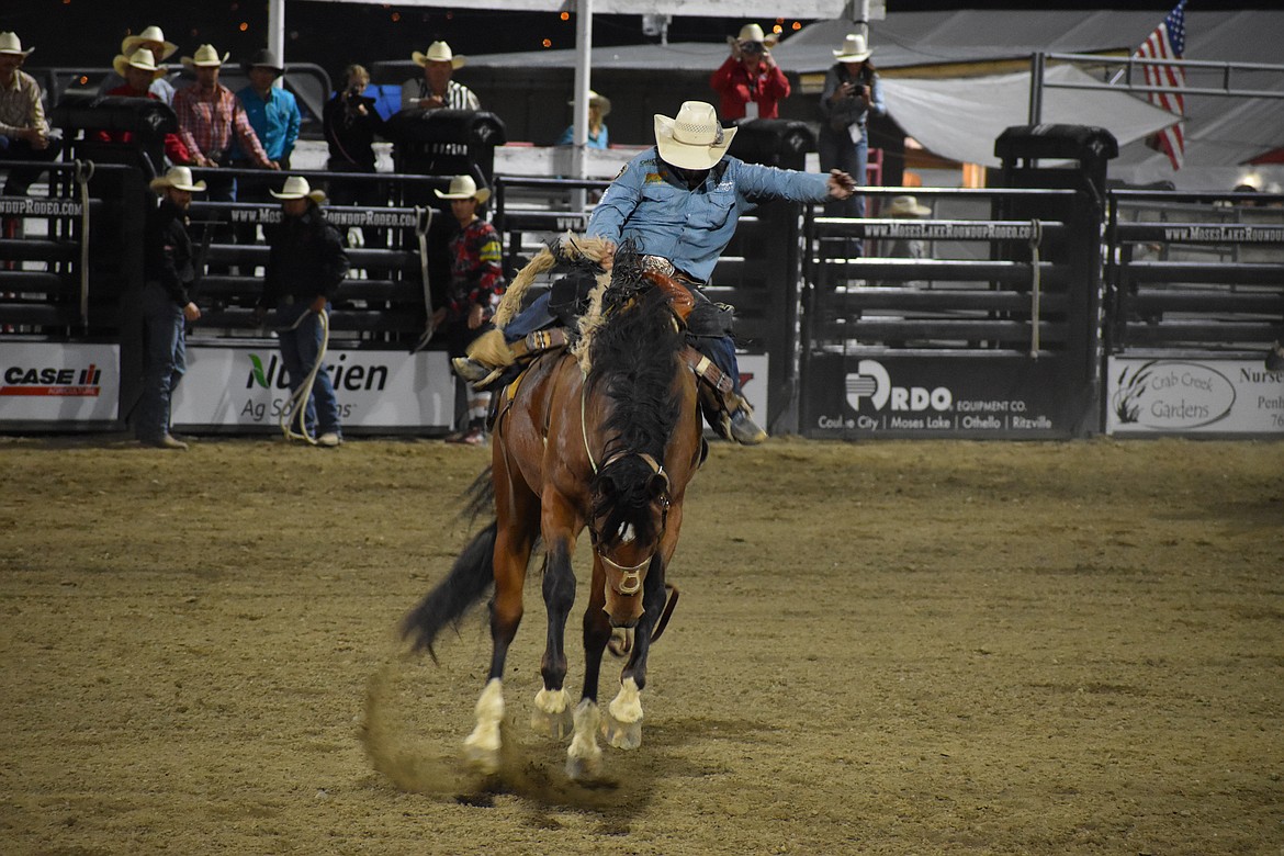 Saddle Bronc rider Wade Sundell of Boxholm, Iowa maintains balance on a horse at the Moses Lake Roundup Rodeo.