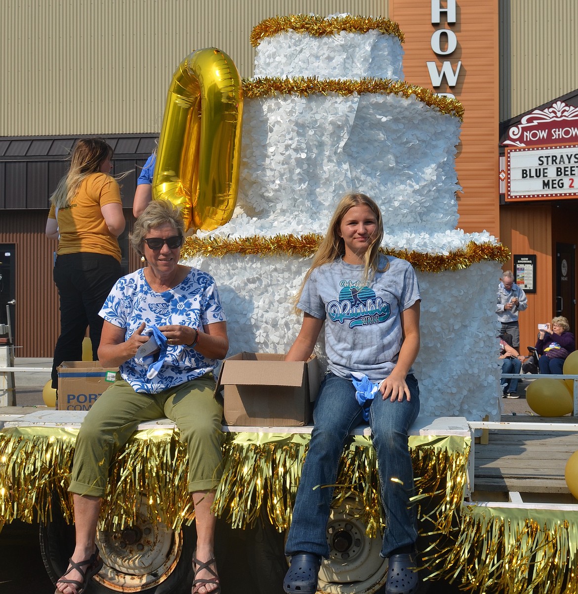 Denise Stanley and Allysa Thoft tossed commemorative socks from this elaborate centennial float during Saturday's parade. (Kristi Niemeyer/Leader)