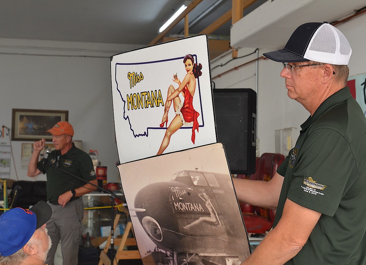 Author and pilot Bryan Douglass explains how Miss Montana got her name during his presentation Saturday at the Polson airport, while fellow pilot Art Dykstra holds up the logo and its inspiration. (Kristi Niemeyer/Leader)