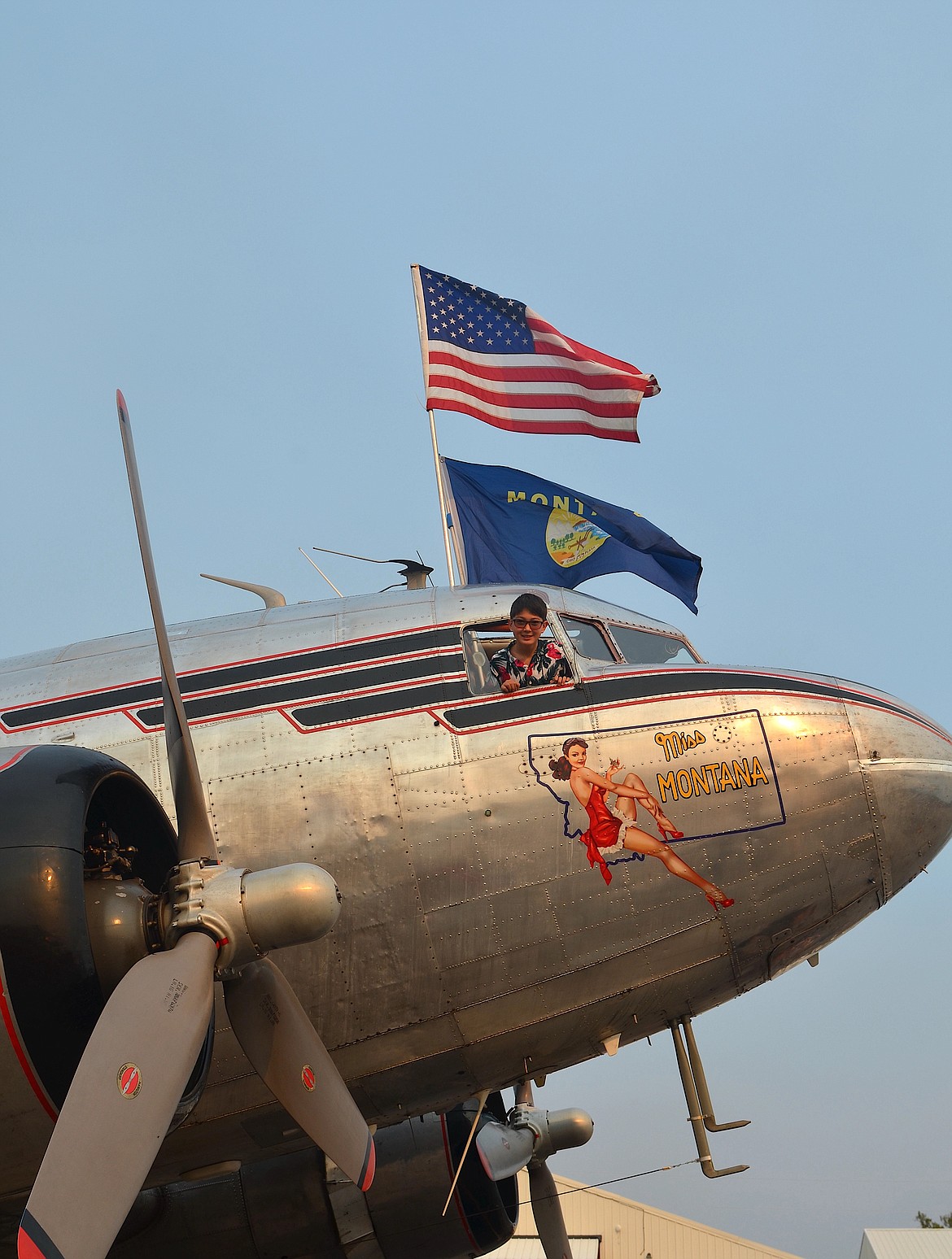 Young copilot takes a turn in the cockpit of Miss Montana when the C-47 visited Polson Saturday to raise funds for the North Lake County Library's renovation effort. (Kristi Niemeyer/Leader)