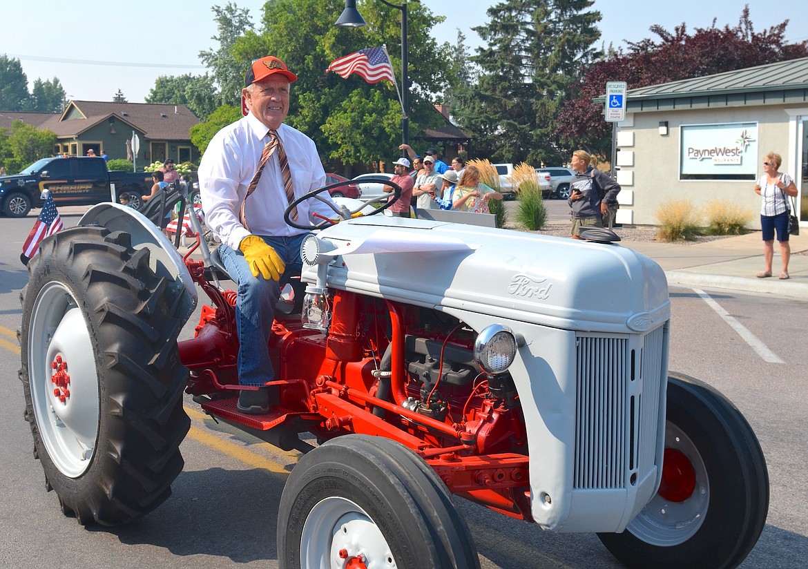 Commissioner Gale Decker piloted his vintage Ford tractor in Saturday's Centennial Parade. (Kristi Niemeyer/Leader)