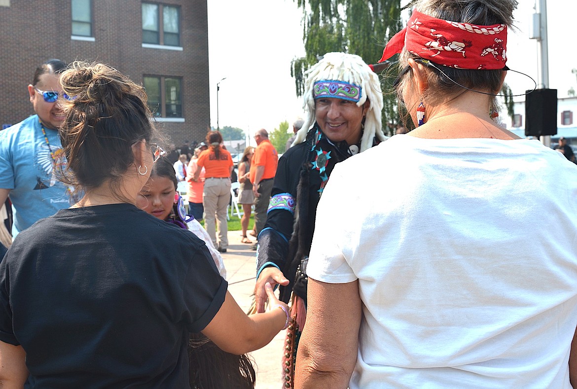 Patrick Matt of the Flathead Reservation Traditional Dance Troupe greets participants in the Round Dance or Friendship Dance during centennial festivities Saturday. (Kristi Niemeyer/Leader)