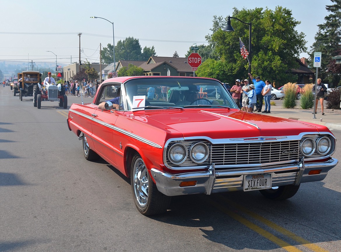 Rob and Danielle Dotson's 1964 Impala squired Lake County Commissioner Steve Stanley in Saturday's centennial parade. (Kristi Niemeyer/Leader)