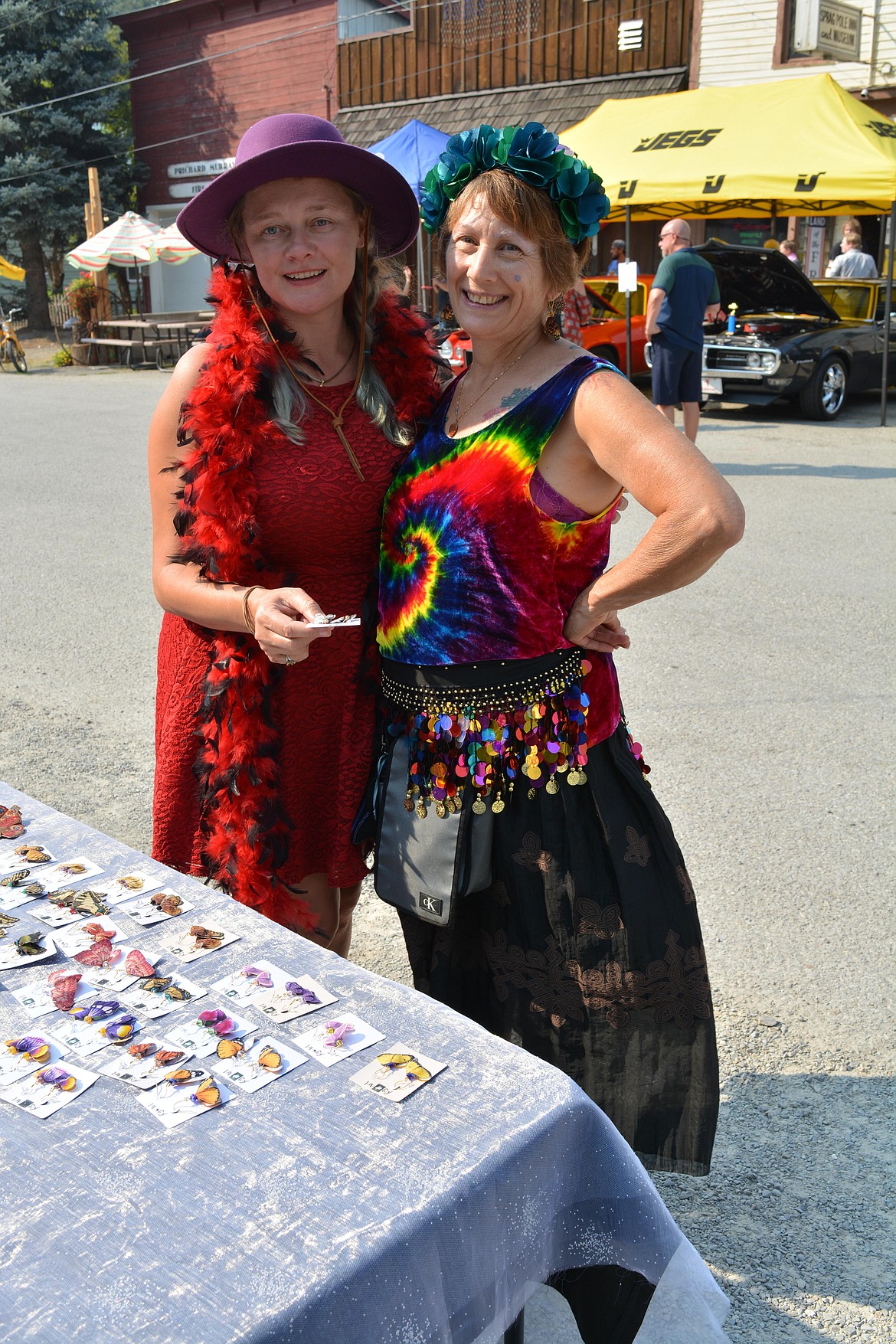 Sadae Lortz and Joy Stewart hug at Stewart's earring booth Saturday at the Molly B'Damn and Goldrush Days in Murray.