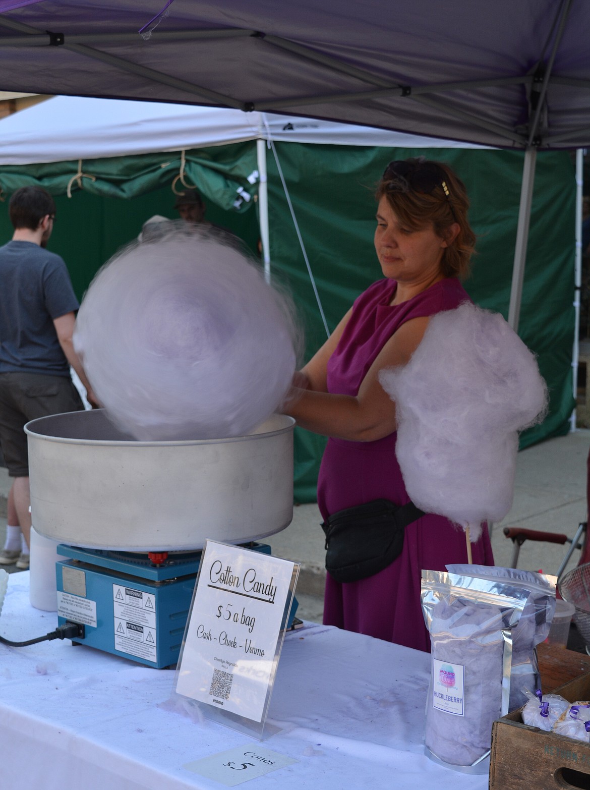 Sherilyn Reynolds of All Wound Up spins huckleberry cotton candy at the Huckleberry Festival in downtown Wallace.