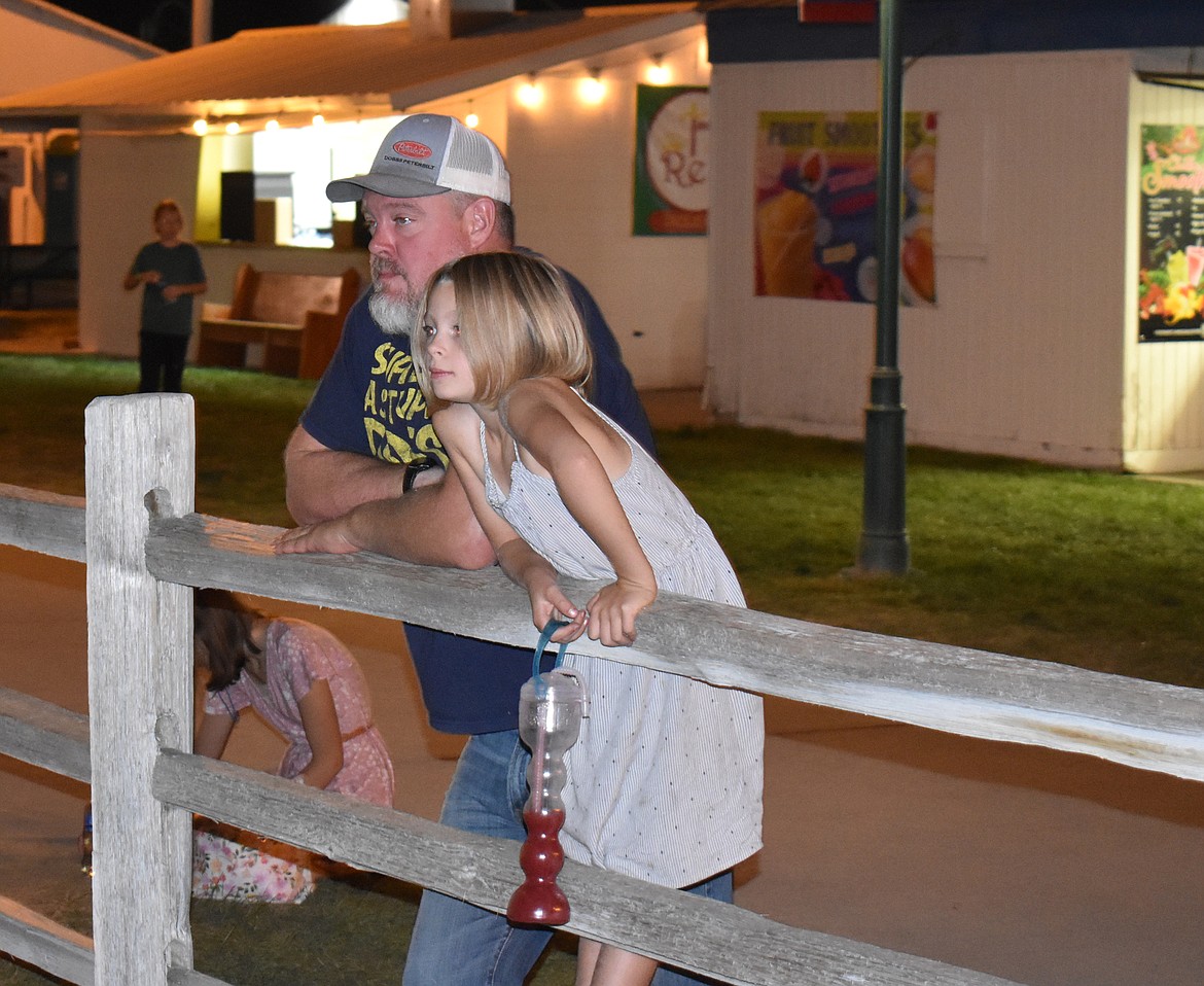 Lindzy Lustig, right, and her dad Tony Lustig, of Moses Lake, enjoy Ned LeDoux’s performance at the Grant County Fair Friday night.