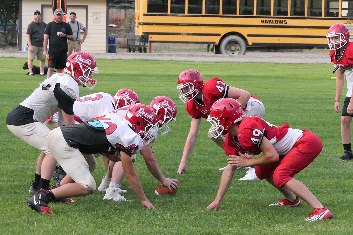 Members of the "red" and "white" teams square off during the Noxon pre-season scrimmage game Friday night in Noxon.  The Red Devils travel to Alberton this Friday for their season opener in 6-player football. (Chuck Bandel/VP-MI)