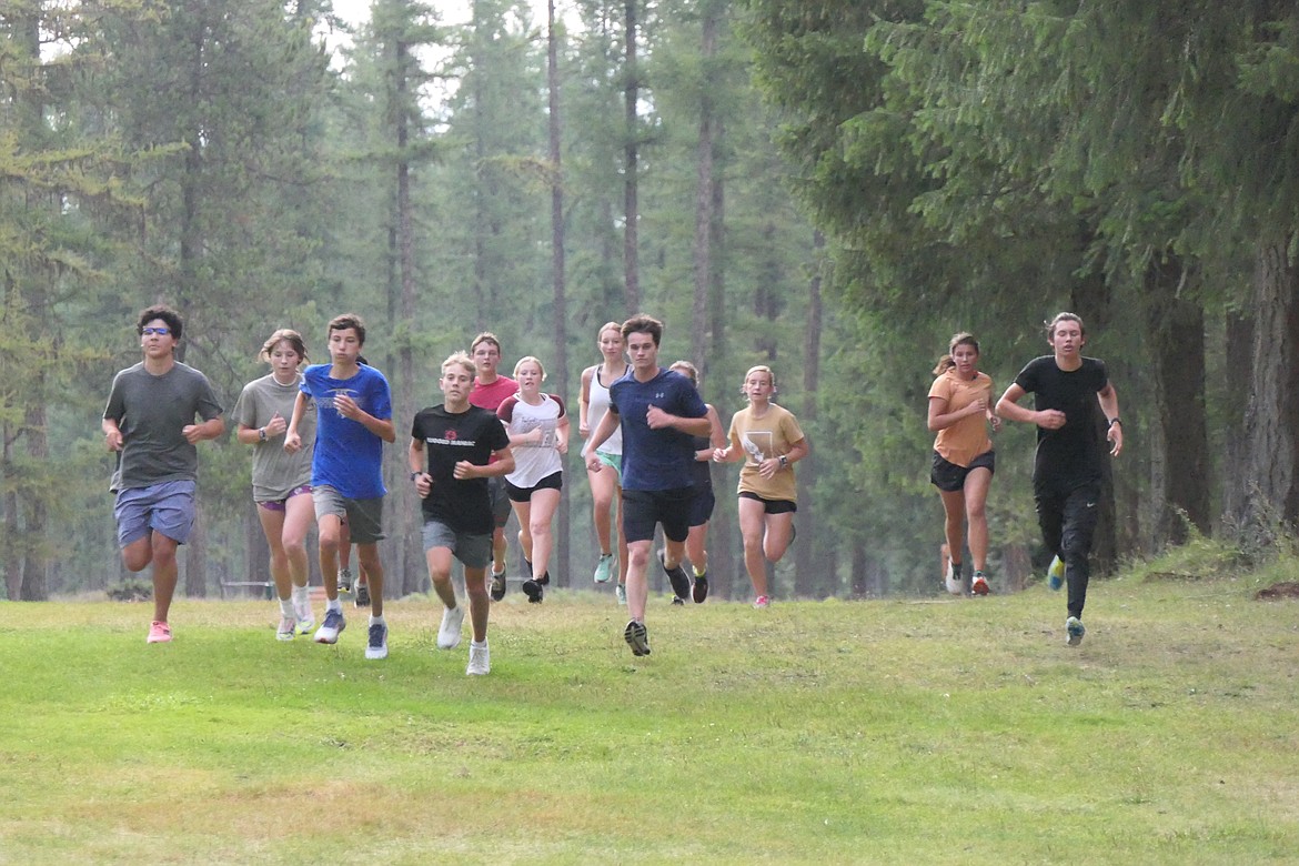 Members of the Thompson Falls cross country team run through the woods at the River's Bend Golf Course near Thompson Falls as they prepare for their season opening race this Saturday at the Deer Lodge Invitational.  (Chuck Bandel/VP-MI)