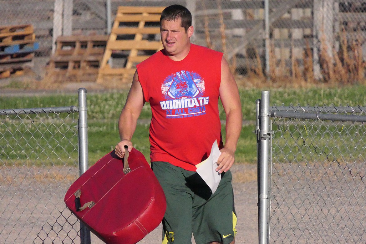 Superior head coach Jeff Schultz brings some tackling pads to the practice field during a recent pre-season workout in Superior.  (Chuck Bandel/MI-VP)