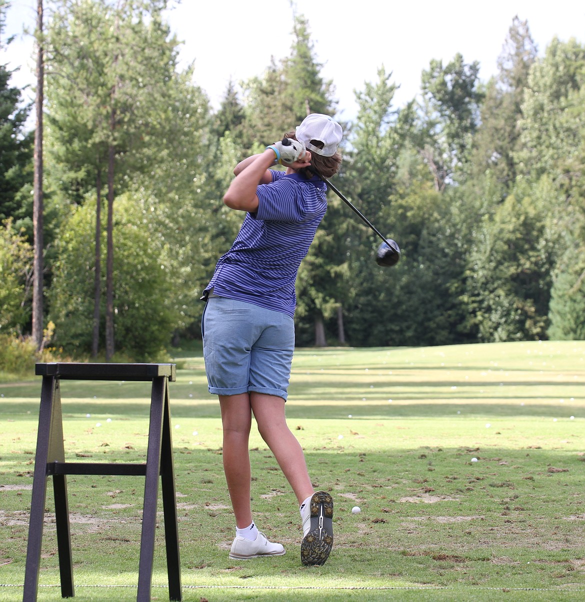 Sandpoint's Micah Young takes a swing at the driving range during a preseason practice at The Idaho Club earlier this month.