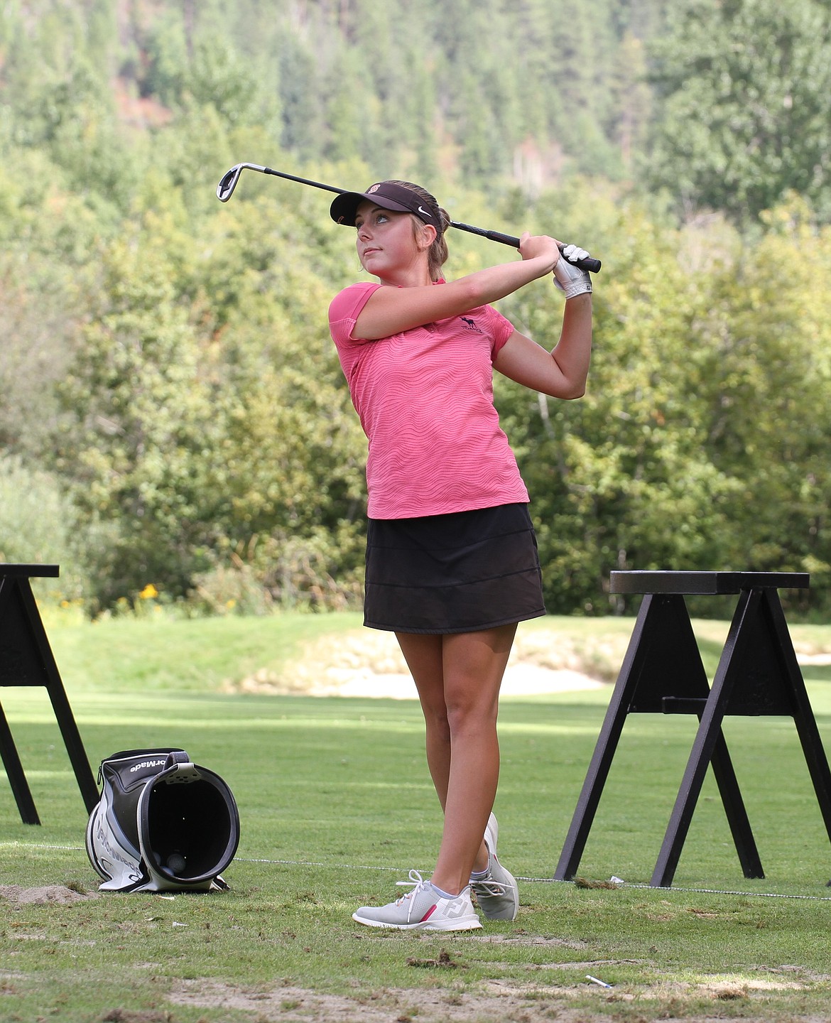 Sandpoint's Taylor Mire takes a swing at the driving range during a preseason practice at The Idaho Club earlier this month.