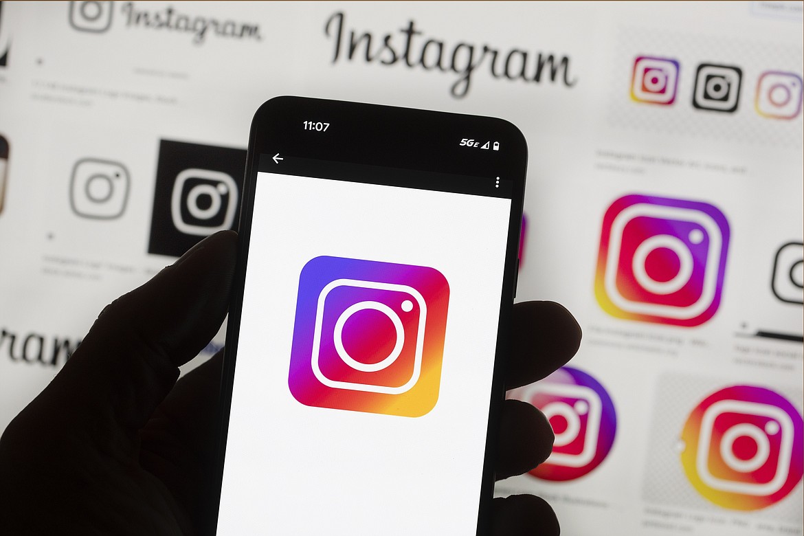 The Instagram logo is seen on a cell phone, Friday, Oct. 14, 2022, in Boston. Google, Facebook, TikTok and other Big Tech companies operating in Europe are facing one of the most far-reaching efforts to clean up what people encounter online. (AP Photo/Michael Dwyer, File)