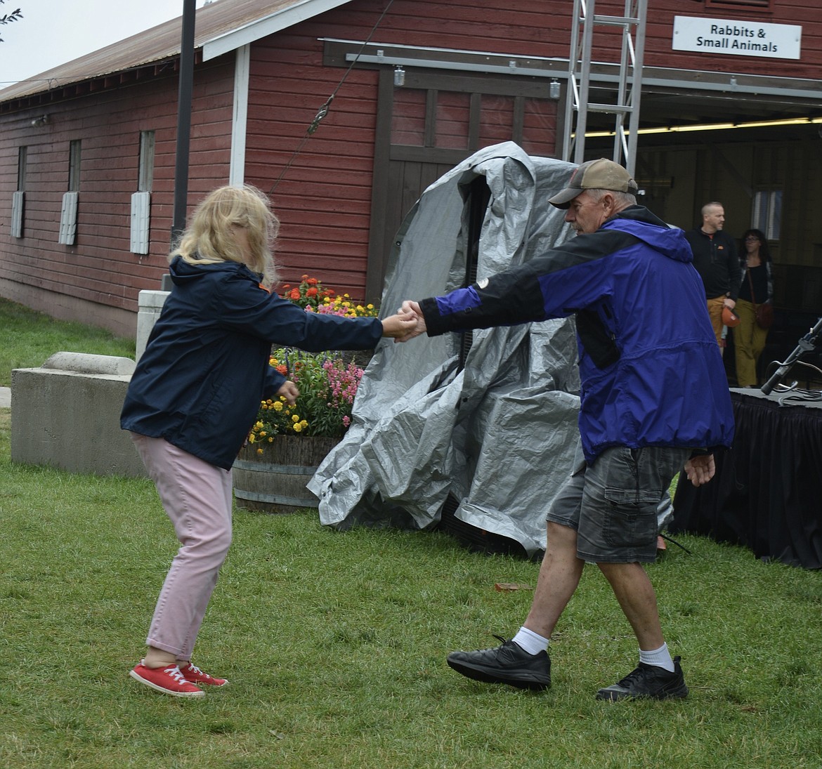 Joyce Crawford and John Ely dance during the afternoon Music on the Midway series. Though it was raining on and off throughout the day, the couple found fun at the Fair regardless.