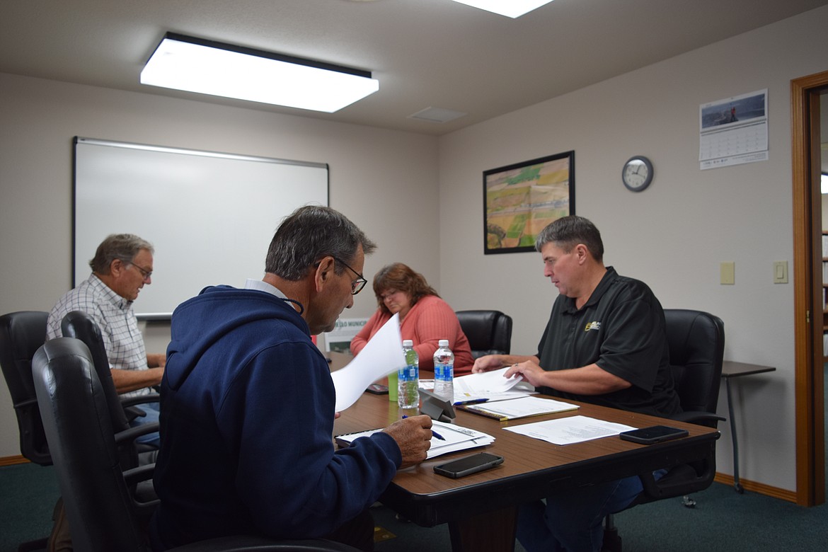 Commissioner Kenny Schutte, middle left, discusses Port of Othello business during Tuesday’s regular meeting. Schutte has been a port commissioner since 2000.