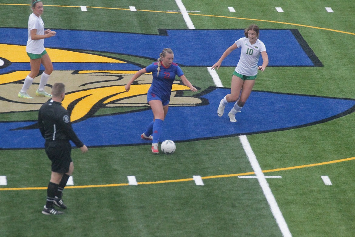 MARK NELKE/Press
Sophie Holecek of Coeur d'Alene maneuvers the ball down the field as Evelyn Bowie (10) and Karstyn Kiefer of Lakeland look on Tuesday night at Coeur d'Alene High, in the first varsity soccer game on the new artificial turf field.