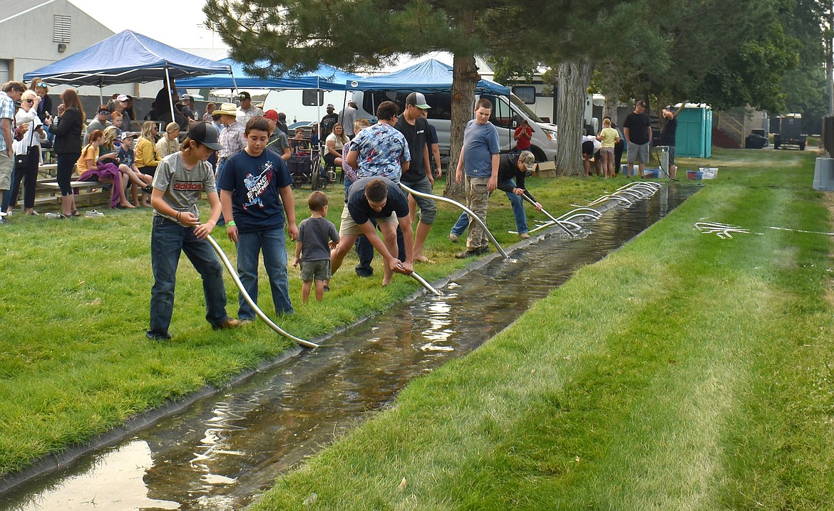 Competitors in the World-Famous Siphon-Setting Contest get in a little practice before the contest starts Saturday morning at the Grant County Fair.