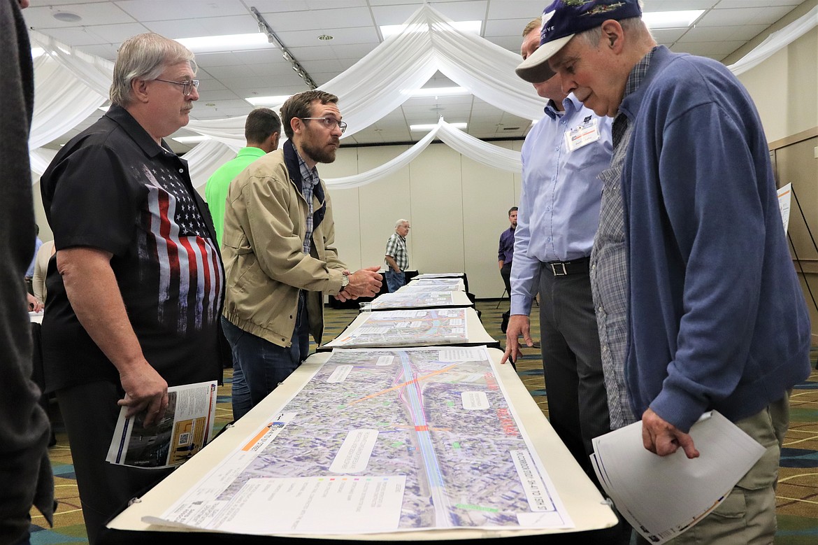 People listen to an Idaho Transportation Department official during an open house on the Interstate 90 corridor Tuesday at the Best Western Plus Coeur d'Alene Inn.
