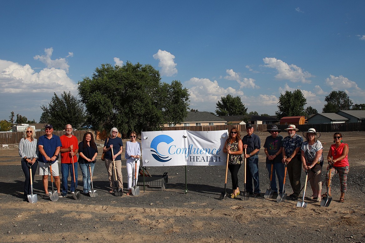 Representatives of Confluence Health and the Columbia Basin Cancer Foundation, including the foundation’s Executive Director, Angel Ledesma, to the right of the sign, at the groundbreaking ceremony in September 2022 for the incoming Confluence Health Radiation Treatment Facility set to open the second week of October.