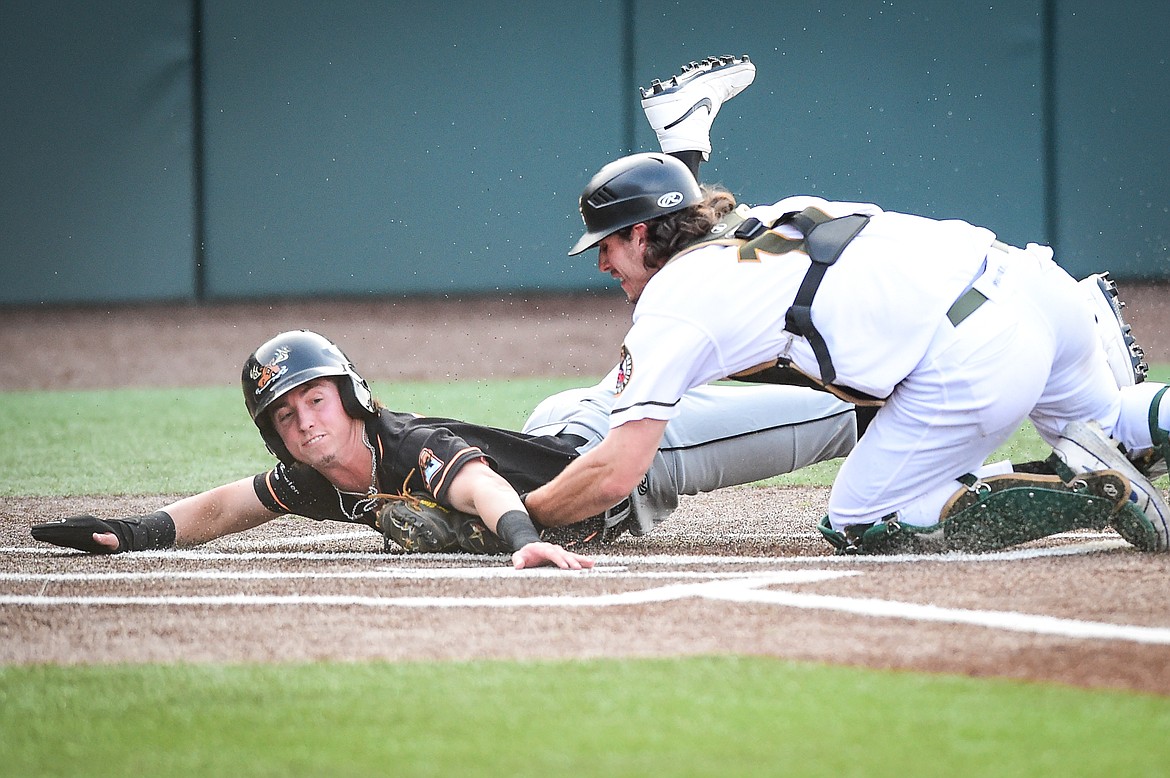 Missoula's Ryan Cash (7) is tagged out on a play at the plate by Glacier catcher Matt Clayton (11) on a throw from left fielder Christian Kirtley after trying to score from second base in the second inning. (Casey Kreider/Daily Inter Lake)