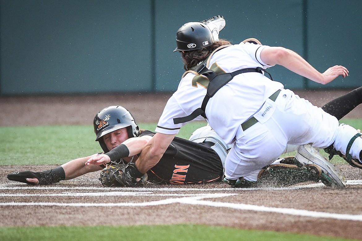 Missoula's Ryan Cash (7) is tagged out on a play at the plate by Glacier catcher Matt Clayton (11) on a throw from left fielder Christian Kirtley after trying to score from second base in the second inning. (Casey Kreider/Daily Inter Lake)