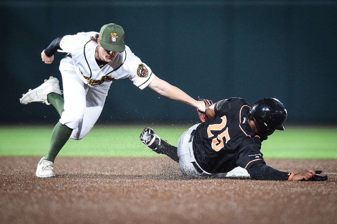 Glacier second baseman Colin Gordon (8) tags out Missoula's Dondrei Hubbard (25) trying to steal second base in the seventh inning at Glacier Bank Park on Thursday, Aug. 24. (Casey Kreider/Daily Inter Lake)